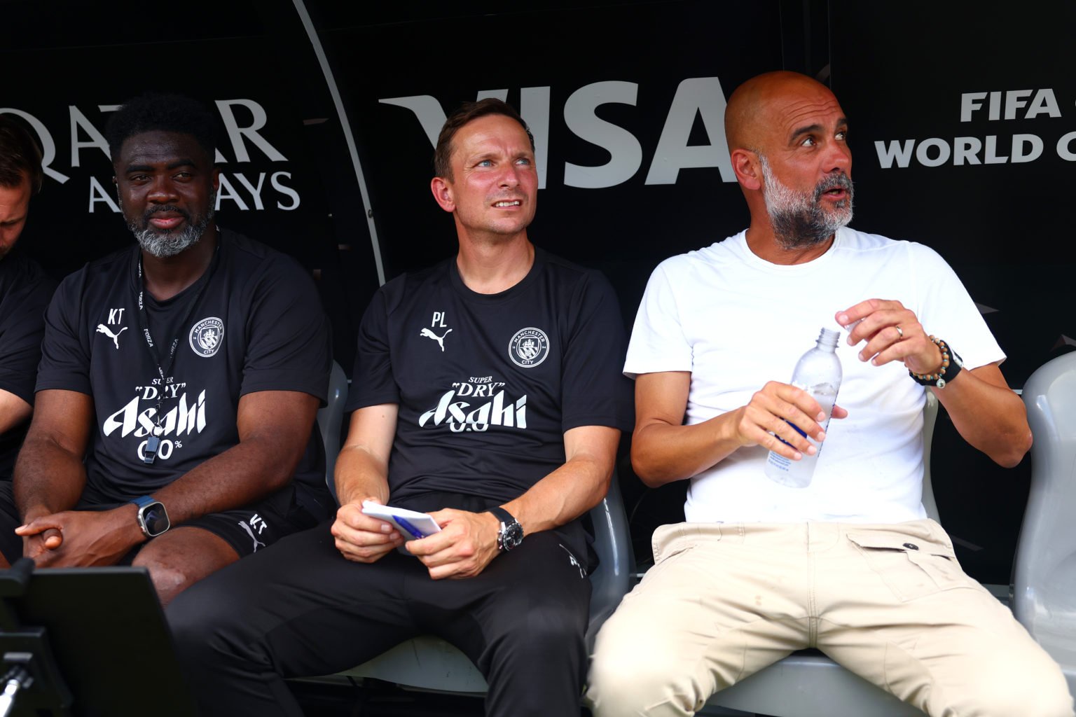 Pep Guardiola sitting with Pep Lijnders and Kolo Toure.